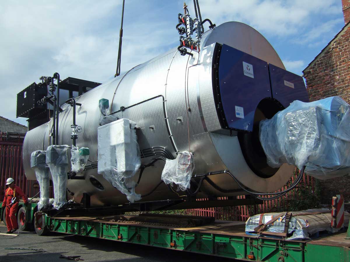 Loading industrial boiler onto transport vehicle for safe removal and recycling